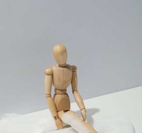 Concept of injury with wooden puppet with bandage